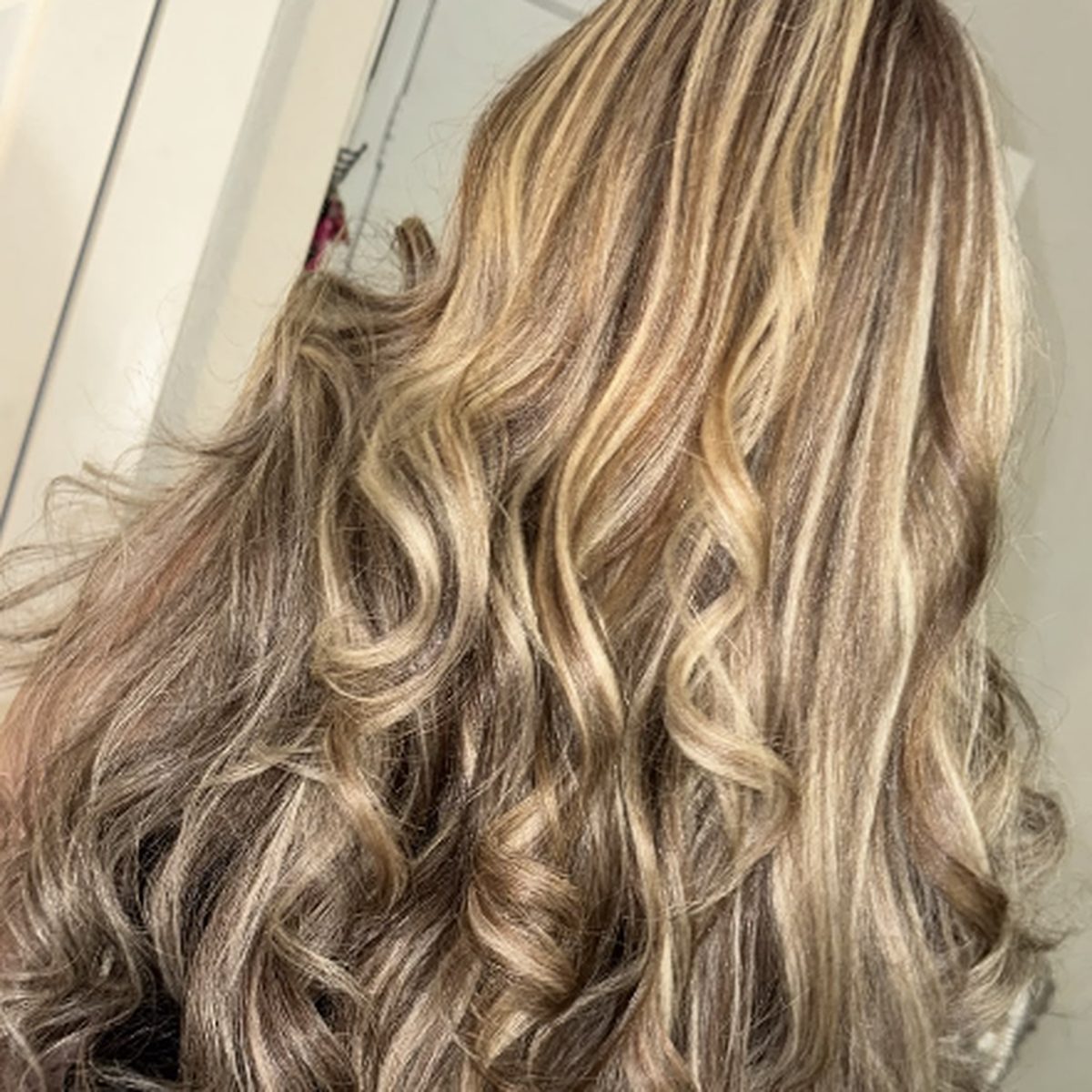 Long wavy hair with blonde and brown highlights