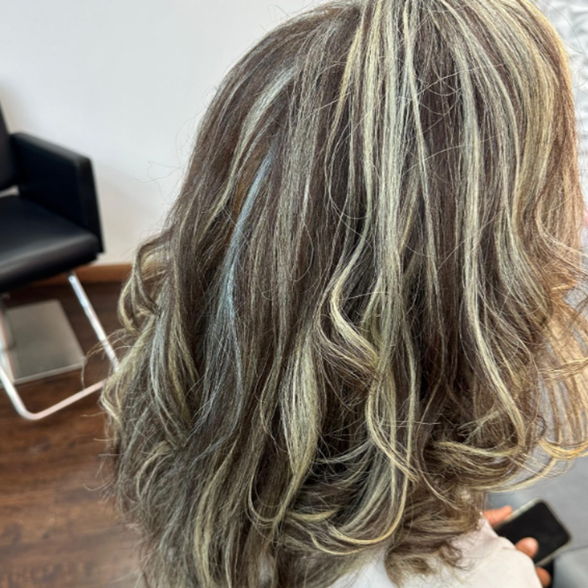 Shoulder-length waves with blonde highlights